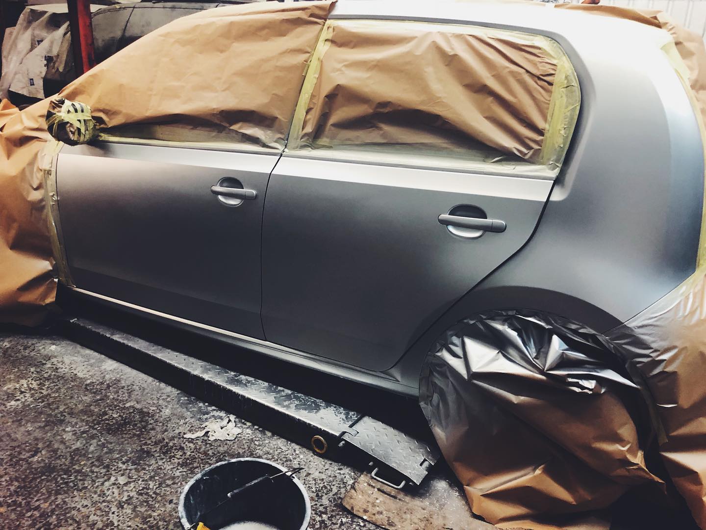Volkswagen Golf masked up and freshly painted in matte grey at ADE Auto Repairs